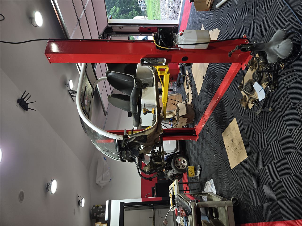 Two GEM carts being serviced inside the workshop
